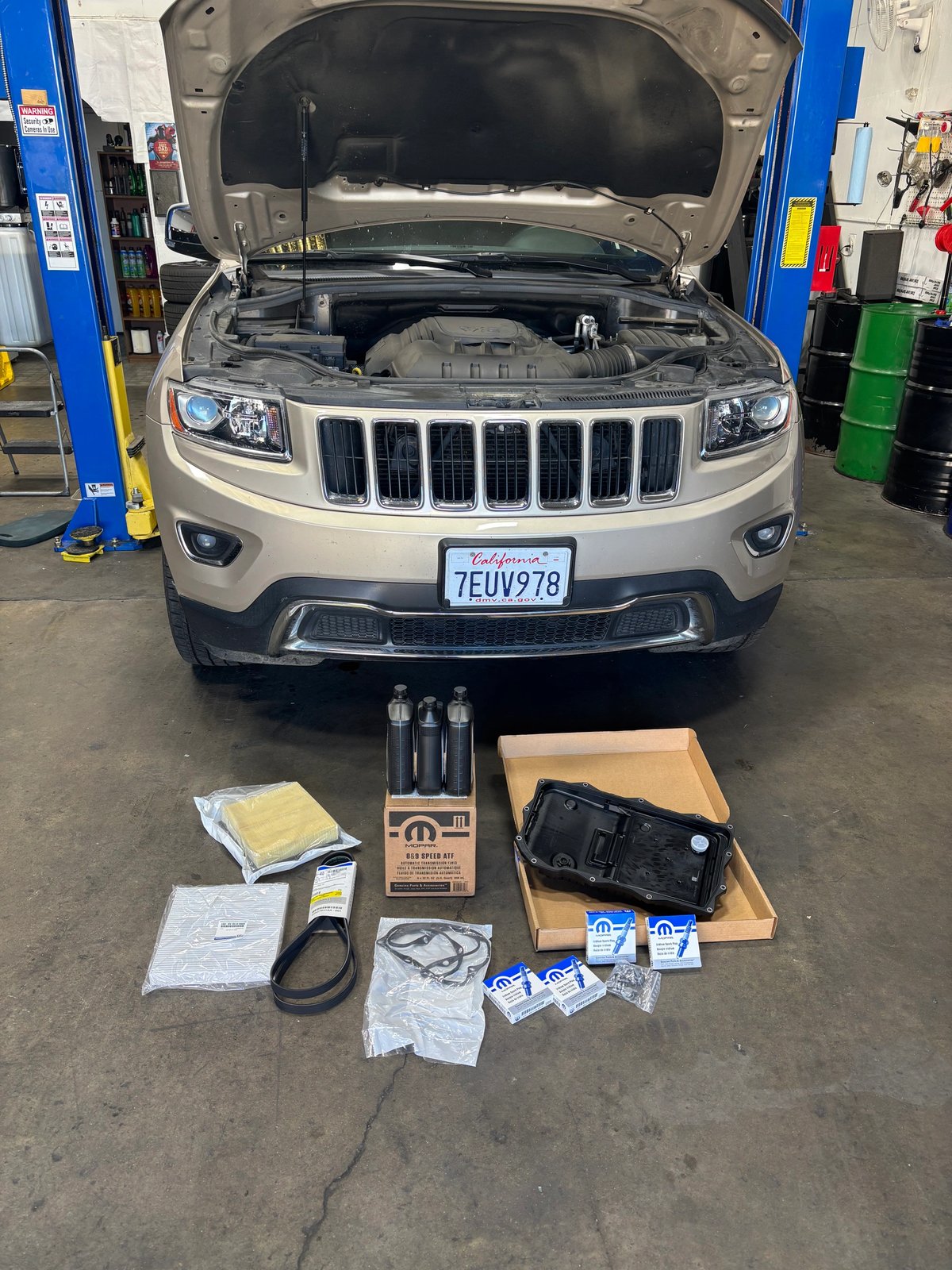 Transmission oil pan, fluids and replacement parts laid out for service