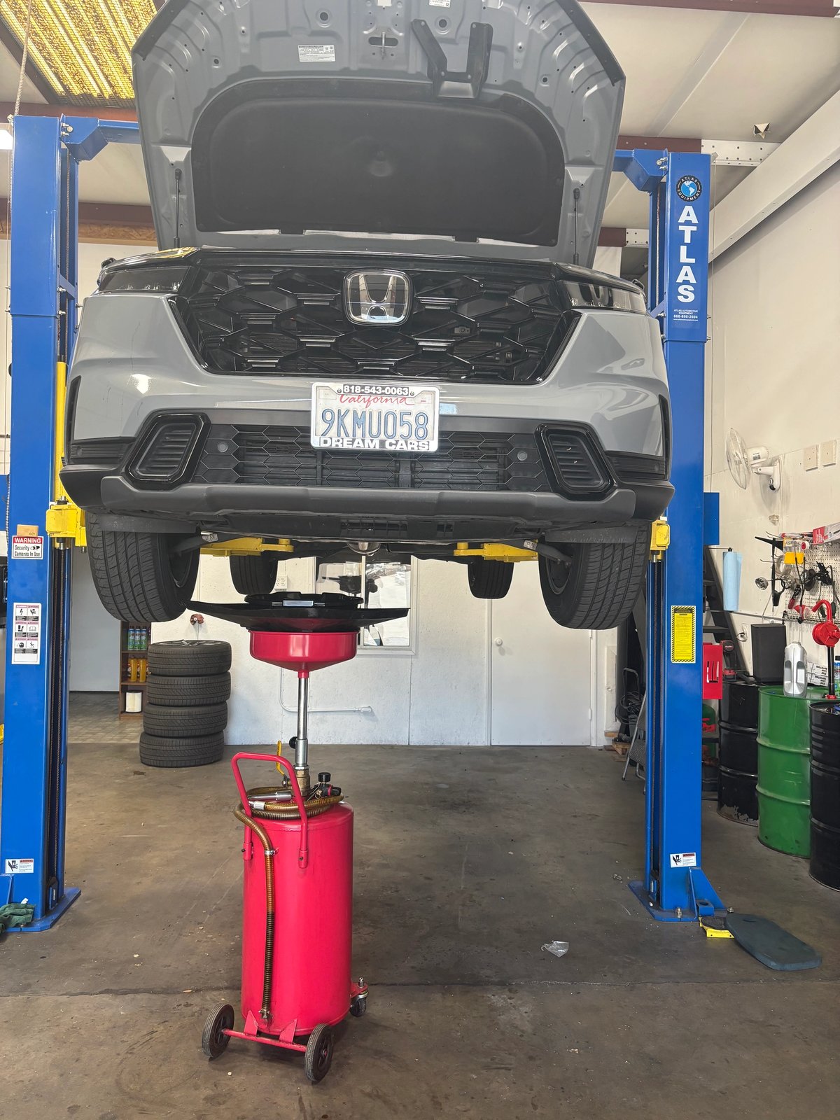 Honda CR-V raised on a lift for oil service at MB Auto Repair